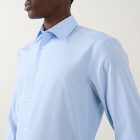 Model wearing Paul Smith Solid Single-Cuff Shirt in blue, showing classic collar and button fastening detail. 100% cotton slim fit.