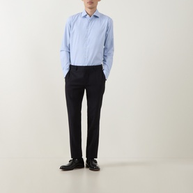 Model wearing Paul Smith Blue Single Cuff Slim formal shirt with navy tailored trousers and black leather shoes.