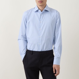 Model wearing Paul Smith blue slim fit single cuff cotton formal shirt, styled with navy trousers.
