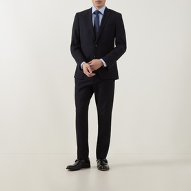 Model wearing Paul Smith Blue Single Cuff Slim formal shirt, styled with dark navy suit, blue tie, and black dress shoes.