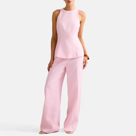 Model wearing Forever New Candy Hearts pink wide-leg trousers and matching sleeveless peplum top, styled with nude heeled sandals.