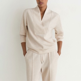 Model wearing Reiss neutral marl wrap-style sweatshirt with matching wide-leg trousers, hands in pockets