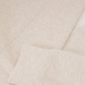 Reiss womenswear neutral marl knit fabric close-up, showing fine textured weave and ribbed cuff detail.