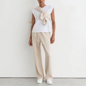 Model wearing Reiss neutral marl wide-leg drawstring trousers, styled with a white sleeveless top and tied scarf.