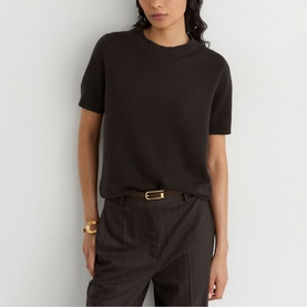 Model wearing Reiss grape burgundy short-sleeve knit top, styled with matching tailored trousers and gold cuff bracelet.