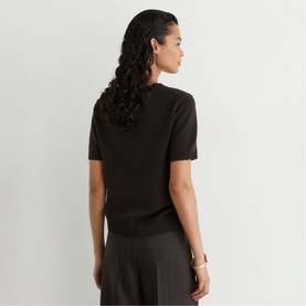 Model wearing Reiss grape burgundy short-sleeve fine knit top, shown from behind, styled with dark wide-leg trousers.