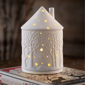 Belleek Forest LED Votive Light in white porcelain with embossed forest scene, glowing warm LED light, house-shaped design