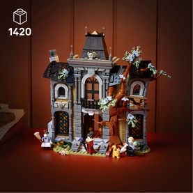 Lego Icons haunted house building set with 1420 pieces, featuring a spooky grey stone mansion, bare tree, and mini figures