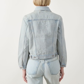 Model wearing Levi's The Original Trucker Jacket in De Oro Trucker light wash denim, back view, styled with matching light wash jeans.