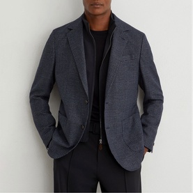 Model wearing Reiss blue houndstooth blazer, styled with a black zip-neck top and black trousers