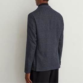 Model wearing Reiss blue houndstooth blazer, rear view, paired with black trousers