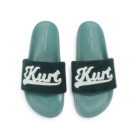 Kurt Geiger London green velvet slide sandals with embroidered Kurt logo strap and teal footbed, top-down view