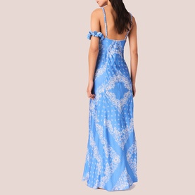 Model wearing blue and white paisley print maxi dress with spaghetti straps and cold-shoulder ruffle detail, back view
