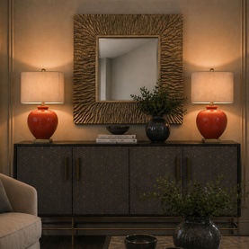 Mindy Browne Lottie Table Lamp in red ceramic with linen shade and brass detail, styled on a dark sideboard with decorative mirror.