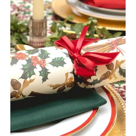 Celebration Crackers 6 Pack Verdant Spice Christmas Crackers with holly print, red double bow, green napkin, styled on festive table setting