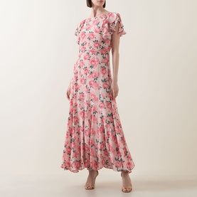Model wearing Queens of Archive Greta Antique Rose Dress in Antique Rose Garden, maxi length with flutter sleeves and floral print godet skirt.