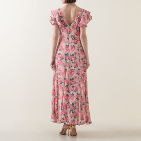 Model wearing Queens of Archive Greta Antique Rose Dress in Antique Rose Garden, showing V-shaped back, flutter sleeves and floral maxi skirt.