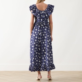 Model wearing Queens of Archive Devon Prairie Floral Dress in Prairie Rose Blue, back view showing bow waist, flutter sleeves and frill hem midi skirt