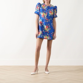 Model wearing Queens of Archive Margot Dutch Floral Mini Dress in Dutch Floral Cobalt, with white kitten heel mules