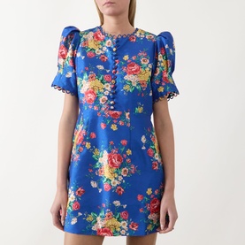 Model wearing Queens of Archive Margot Dutch Floral Mini Dress in Cobalt, with puff sleeves, button bodice, and scallop trim detailing.