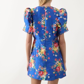 Model wearing Queens of Archive Margot Dutch Floral Mini Dress in Dutch Floral Cobalt, rear view showing puff sleeves and A-line silhouette