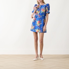 Model wearing Queens of Archive Margot Dutch Floral Mini Dress in Dutch Floral Cobalt, styled with white heeled mules.