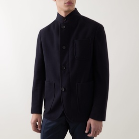 Model wearing Corneliani Stand-Collar Wool Jacket in navy, featuring button fastenings and patch pockets, styled with navy trousers.