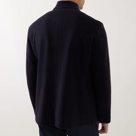 Model wearing Corneliani Stand-Collar Wool Jacket in navy, rear view showing clean back seam and long sleeves.