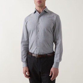 Model wearing grey micro-check cotton dress shirt, styled with dark trousers and brown leather belt