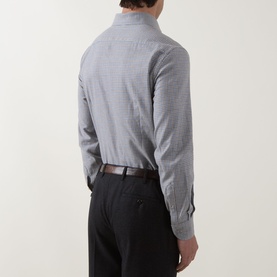Model wearing grey micro-check dress shirt, styled with dark trousers and brown leather belt, rear view