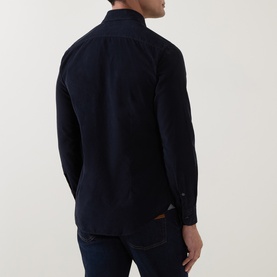 Model wearing Corneliani navy cotton casual shirt, back view, styled with dark indigo jeans