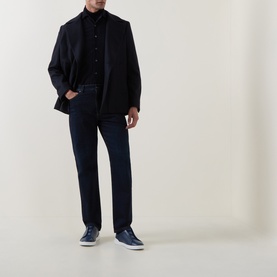Model wearing Corneliani navy cotton casual shirt, styled with dark blazer, navy jeans and navy trainers.