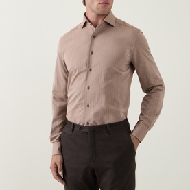 Model wearing Corneliani Herringbone Tonal Striped Shirt in beige, styled with dark brown trousers. Spread collar, long sleeves, front button
