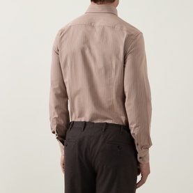 Model wearing Corneliani Herringbone Tonal Striped Shirt in beige, back view, with dark trousers. Long sleeves with buttoned cuffs.