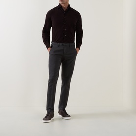 Model wearing dark charcoal slim-fit trousers styled with a dark burgundy shirt and brown leather shoes