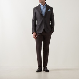 Model wearing Corneliani light blue casual cotton shirt, styled with dark grey blazer, brown tailored trousers and black leather shoes.