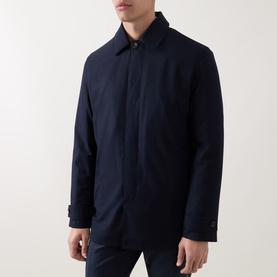 Model wearing Corneliani Technical Waterproof Car Coat in navy, featuring concealed button placket, spread collar, and snap button cuffs