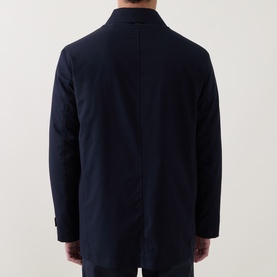 Model wearing Corneliani Technical Waterproof Car Coat in navy, rear view showing clean back seam and structured fit.