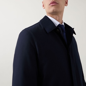 Model wearing Corneliani Technical Waterproof Car Coat in navy, styled with white shirt and navy tie, close-up of collar and chest detail.