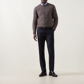 Model wearing Corneliani Chunky Knit Sweater in brown with crew neck, styled with navy trousers and a blue shirt.