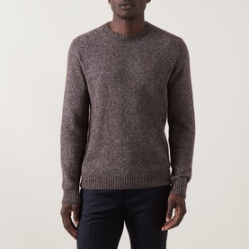 Model wearing Corneliani Chunky Knit Sweater in brown, crew neck, ribbed trims, alpaca blend, styled with dark navy trousers.