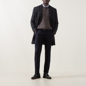 Model wearing Corneliani Chunky Knit Sweater in brown with crew neck, styled with dark overcoat, navy trousers and black leather shoes.