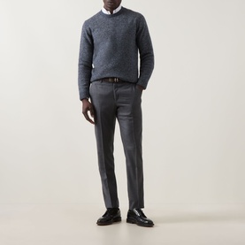 Model wearing Corneliani Chunky Knit Sweater in blue with crew neck, styled with grey trousers, white shirt and dark loafers.