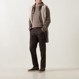 Model wearing Corneliani Logo Knitted Sweater in taupe crew neck, styled with a shearling coat, dark trousers and suede trainers.