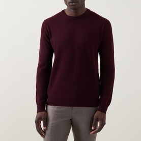 Model wearing Corneliani burgundy wool-cashmere crew neck jumper, styled with grey trousers.