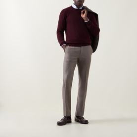 Model wearing Corneliani burgundy wool-cashmere crew neck jumper, styled with taupe trousers, blue shirt and dark blazer.
