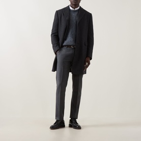 Model wearing Corneliani Straight Leg Formal Trousers in grey, styled with a dark overcoat, grey knit, and black leather shoes.