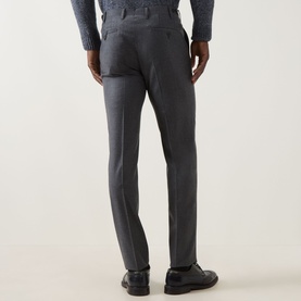 Model wearing Corneliani Straight Leg Formal Trousers in grey wool, shown from rear, styled with a blue shirt and black leather shoes.