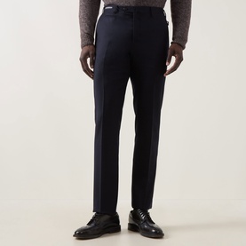 Model wearing Corneliani Straight Leg Formal Trousers in navy with pressed creases, styled with a grey knit and black leather shoes.