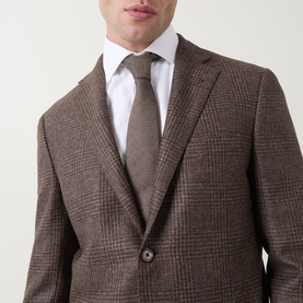 Model wearing Corneliani Boucle Checked Single-Breasted Blazer in brown wool, styled with white shirt and brown tie.